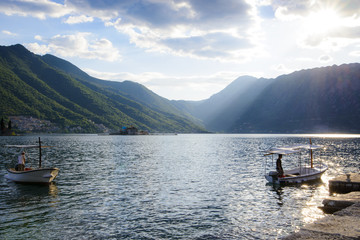Boats at the pier in the bay at sunset