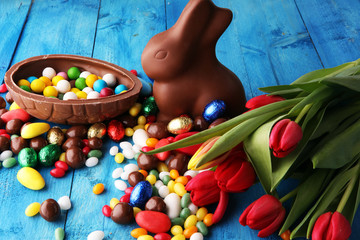 Chocolate Easter eggs and bunny with fresh easter flower