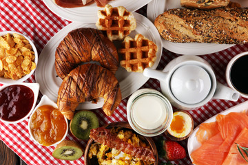 breakfast on table with waffles, croissants, coffe and juice