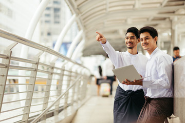Myanmar peoples talking business in city using wireless technology