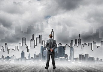 Motivation and inspiration concept with modern cityscape and businessman observing it