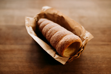 Baked trdelnik. Traditional czech food. Delicious bakery pastry food. Film look toned filter