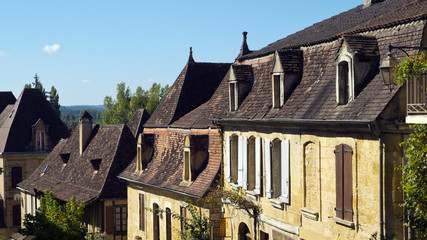 Typically French architecture lines the street in St Cyprien, Dordogne, France