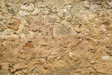 Stone wall covered with mud