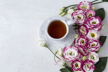 Bouquet of beautiful flowers with cup of tea. Holidays background: March 8, valentine's day, mother's day, wedding, engagement