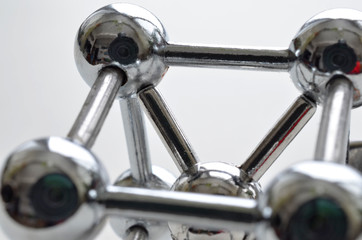 decorative image of an iron molecule made of stainless steel on a white background

