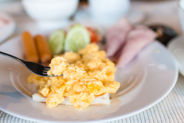 Breakfast with scrambled eggs hotdog Ham and Cucumber.