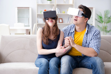 Young family playing games with virtual reality glasses