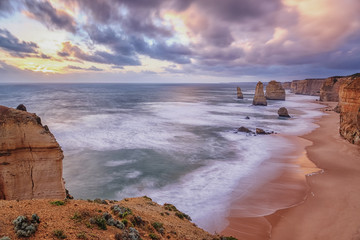 Twelve Apostles rock formation with a pink, blue and yellow sunset sky, Australia