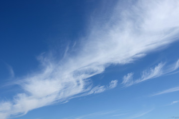 White cirrus clouds in blue sky. Heavenly landscape