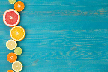 Sliced citrus on blue wooden background. flat lay