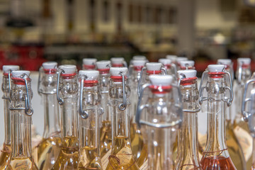 View of spirits bottles standing in a beverage market. Focus on the bottlenecks. Concept: drinks