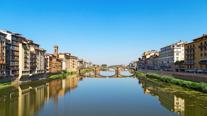 Fototapeta na wymiar Bridge over river Arno in city Florence is called Trinity. Stone bridge of Florence, Italy, June 2017. Ponte Santa Trinita.