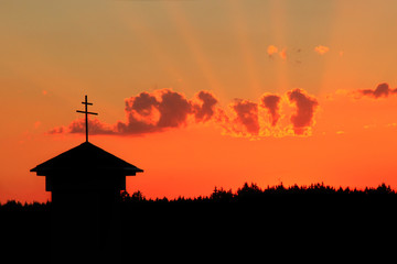 Chapel with a cross in the sunset