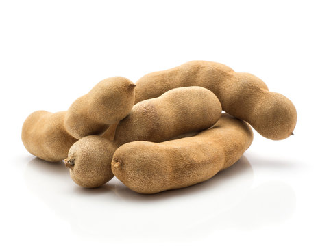 Tamarind four Indian dates in a brown brittle shell isolated on white background.