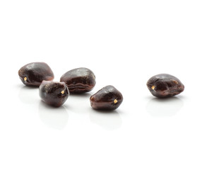 Five tamarind flat glossy seeds isolated on white background Indian dates.