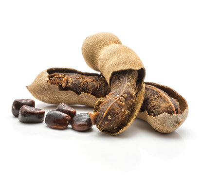 Two open tamarind with glossy seeds isolated on white background Indian dates.