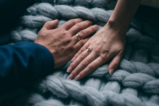 Palms of the newly-married couple with wedding rings