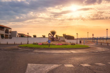 Saintes-Maries-de-la-Mer, beautiful morning at favorite mediterranean resort, tourist route with anchor, symbol of old seaport, Camargue, Provence, France