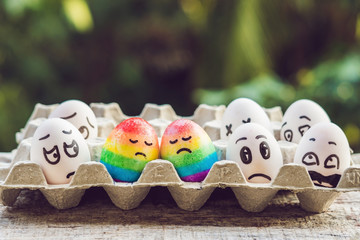 discrimination gay concept. Two rainbow eggs in the form of a homosexual couple. And condemning...