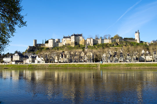 Chinon town with its chateau on the hill above in spring afternoon sunshine on the banks of the River Vienne, Indre-et-Loire, France