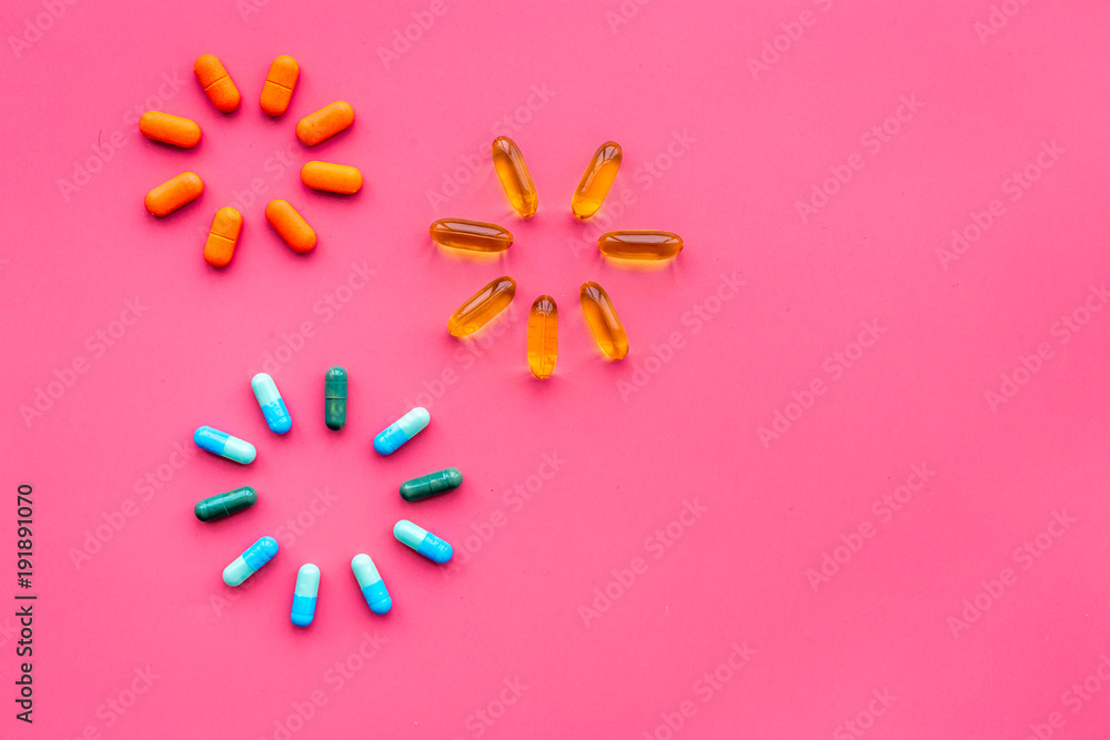 Sticker Color capsules. Medicine pills on pink background top view copy space. Fireworks of flower sign