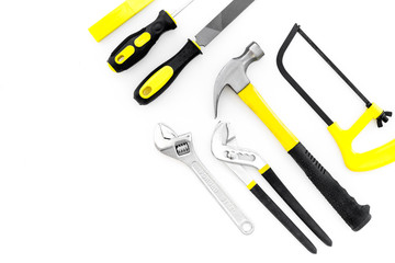 Tools for repair and building. File, saw, hummer on white background top view copy space