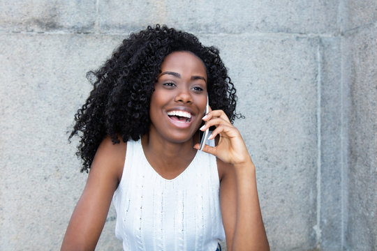 Beautiful african american woman at cellphone