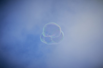 Soap bubble floating with clouds and blue sky in Barcelona