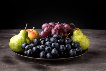 Beautiful Ripe Fruits on Plate Apple Pears and Grapes Dark Photo Dark Background Autumn Seasonal Fruits