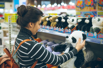Fototapeta na wymiar woman look for soft panda toy