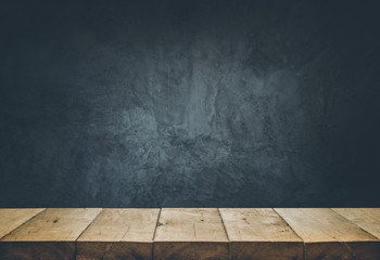 Empty table top with cement wall background.
