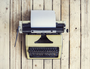 Old Russian typewriter over retro wooden background. Vintage equipment.