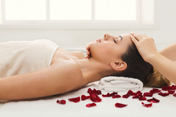 Obraz na płótnie Canvas Woman getting professional facial massage at beauty salon