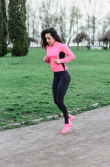 a young girl goes in for sports in the fresh air . Sports clothing pink color