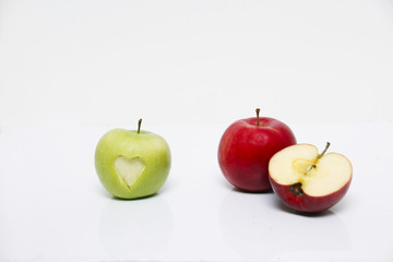 Red and green apple, sliced and love sign engraved