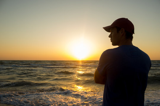 Portrait of a young man in cap on the beach