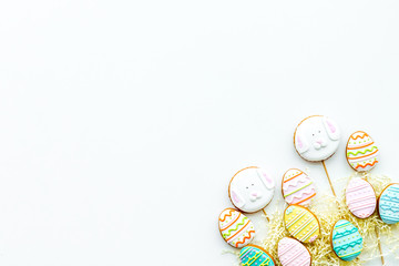 Easter gingerbread and cookies in shape of Easter eggs. White background top view copy space