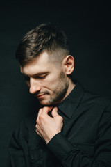 Man in headphones and black shirt on a black background