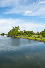Late spring sunshine on colourful narrowboats moored near Splatt Bridge on the Gloucester & Sharpness Canal at Frampton on Severn, Gloucestershire, UK