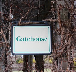 The gatehouse sign in the park on a close up view.