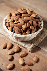 Almond snack fruit in white bowl on wooden