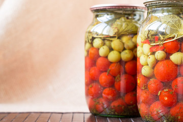 Fototapeta na wymiar A glass jar of canned cherry tomatoes . Series of canned foods