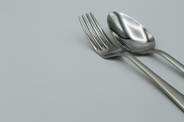 Closed up of silver spoon and fork on table.