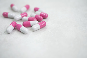 Fototapeta na wymiar pink white medicine pills on white background