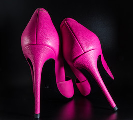 Pink shoes on a black background closeup