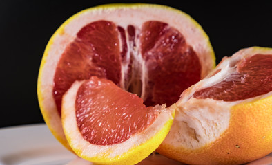 Mature grapefruit on a white plate close-up
