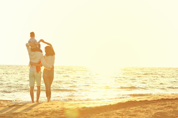 portrait of happy family and baby enjoying sunset in the summer leisure