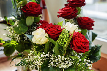Bouquet of beautiful roses and other flowers in the morning sun