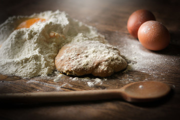 Pasta cooking ingredients on wooden kitchen table. Top view with space for your text, selective focus